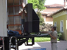 a large tv on a truck lift gate getting moved